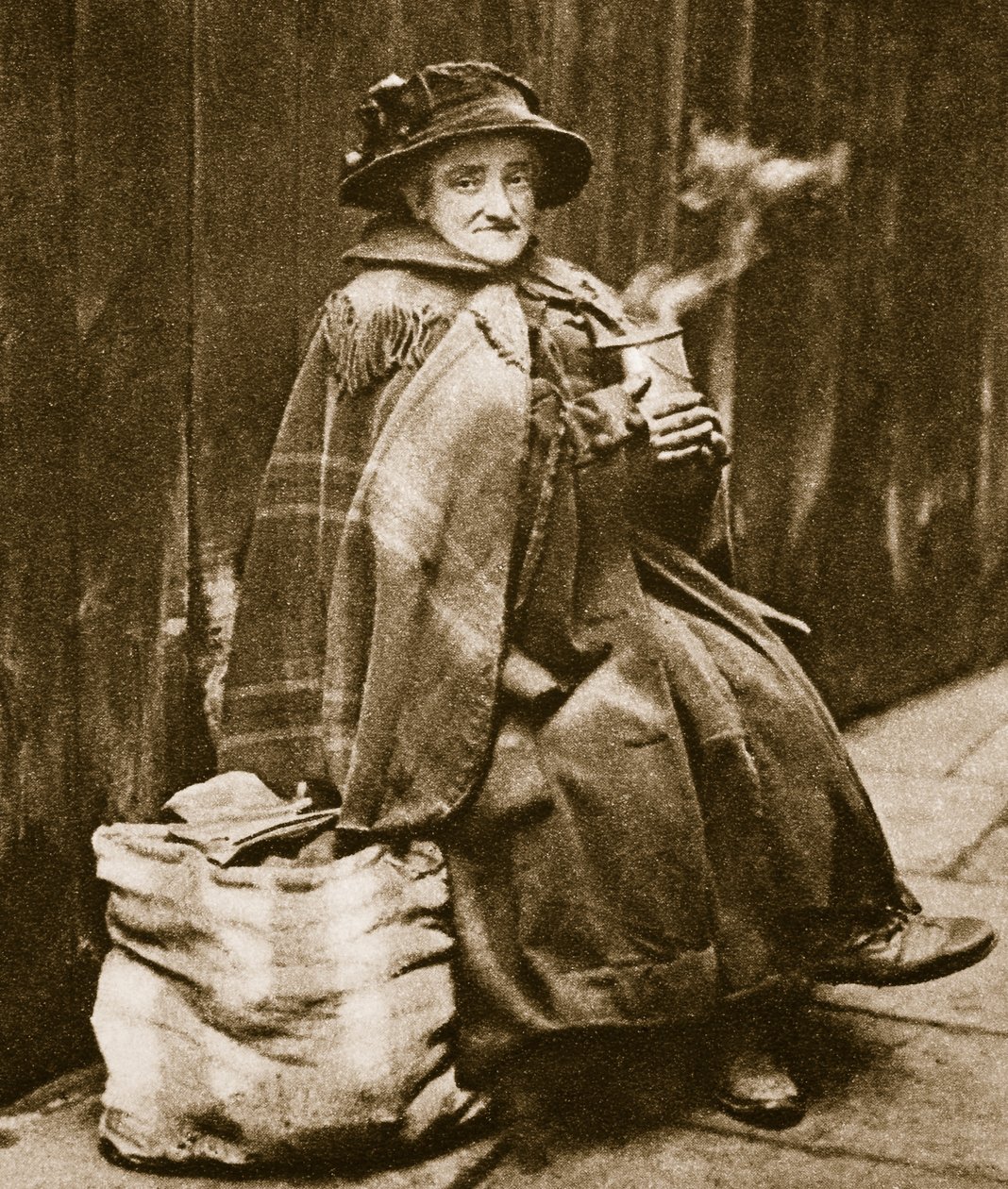 街头女士从典型的东端啤酒罐头喝茶，靠近舰队街（棕褐色照片） 作者 英国摄影师