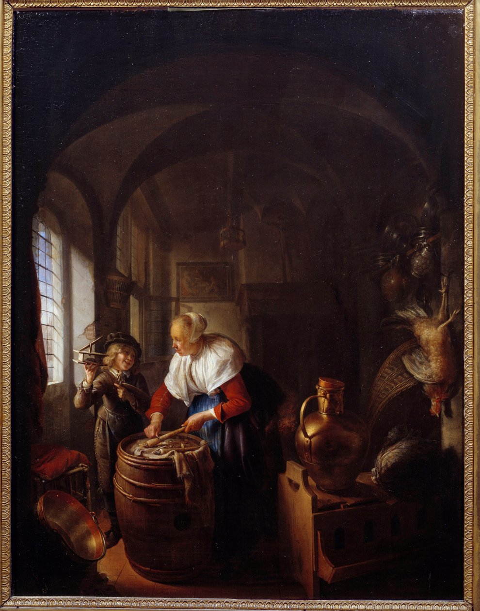 老鼠。 一个孩子向他的母亲展示了一个捕鼠器。 Gerard Dou (1613-1675) 的绘画，霍尔。 作者 葛瑞特窦