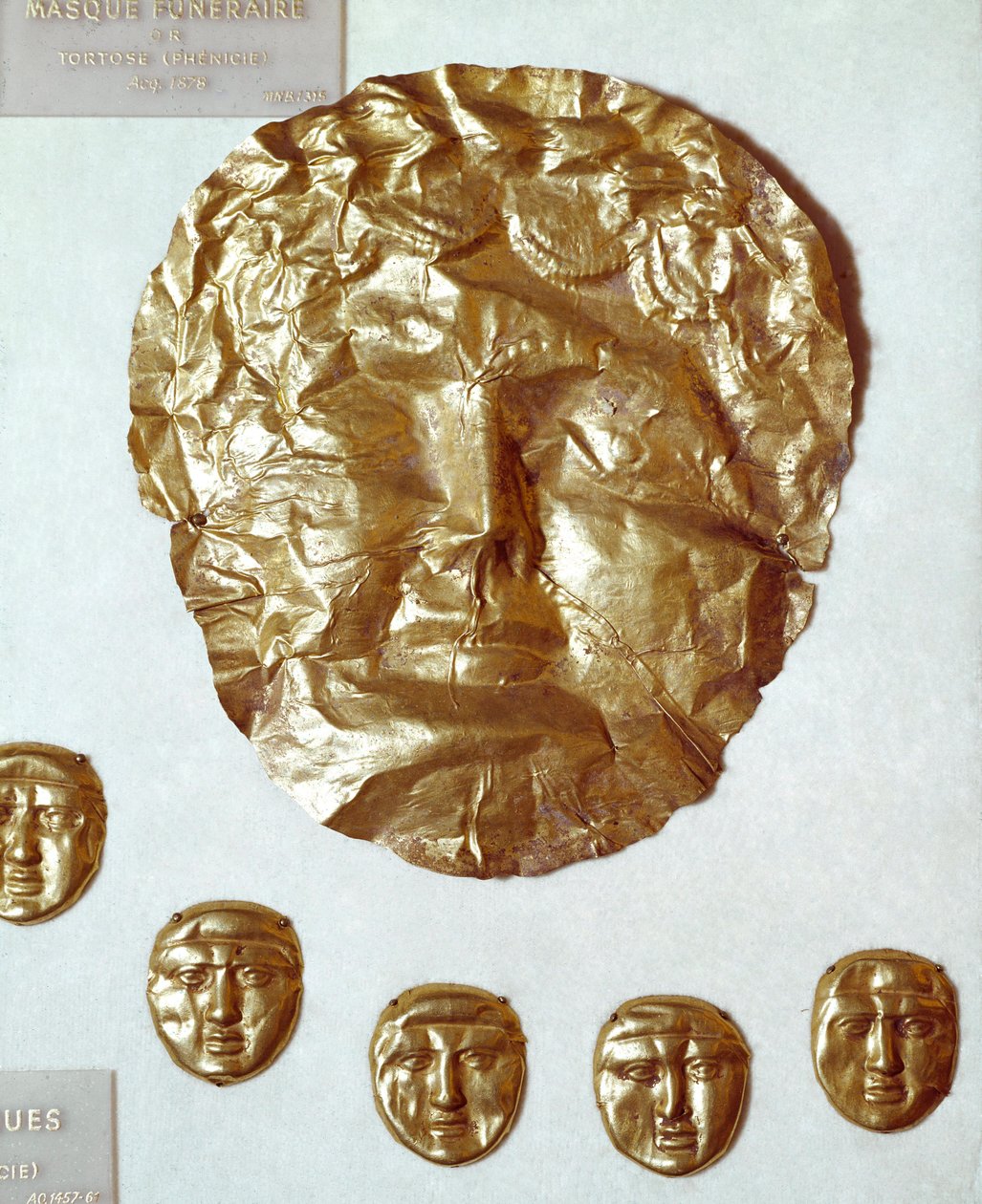 Phenician art: large mask of gold leaf on woman
