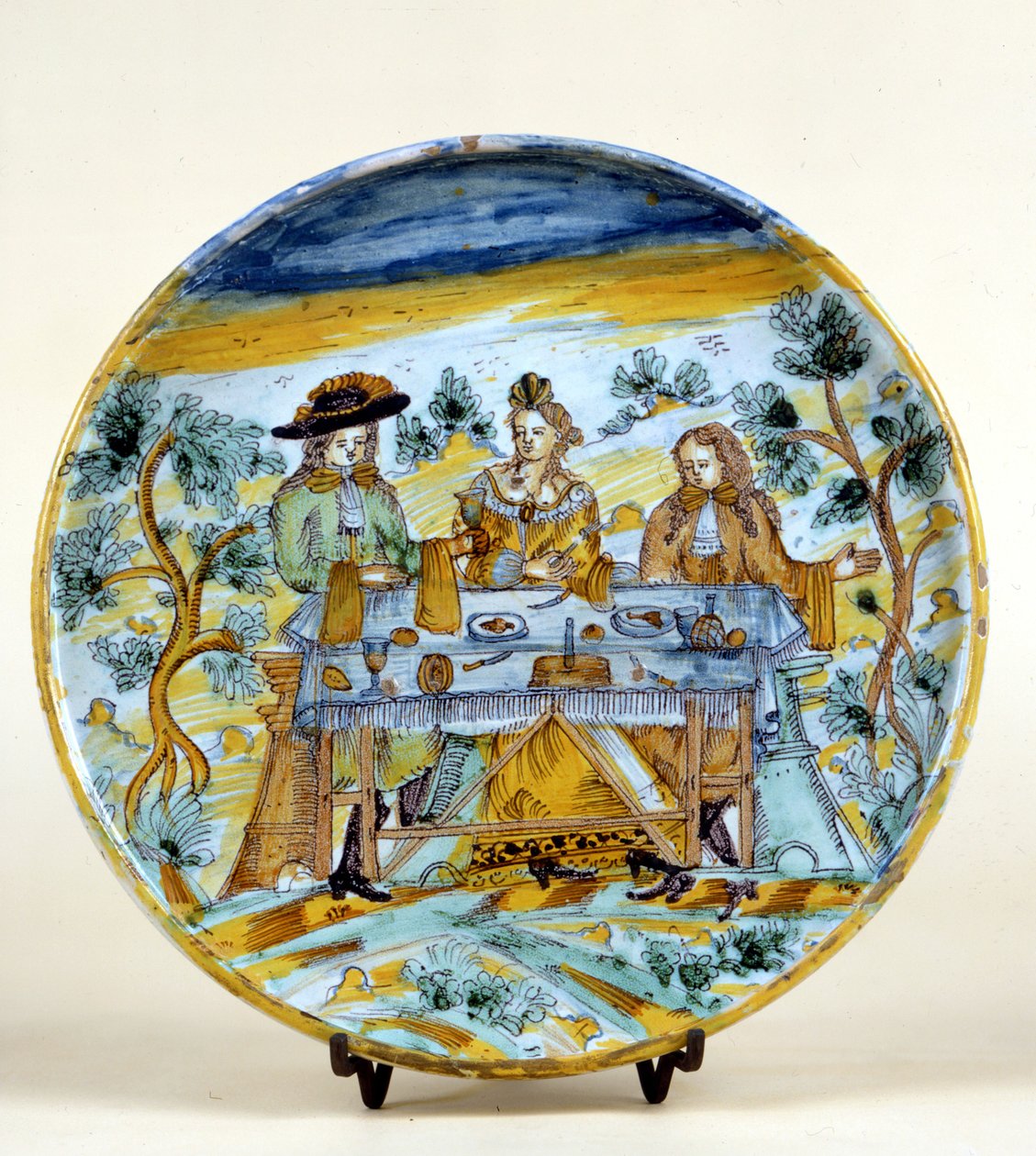塔拉维拉（Talavera de la rejna）（西班牙）陶瓷盘上的户外宴会的表现。16世纪初。米兰，卡斯特罗博物馆。 作者 西班牙语学校