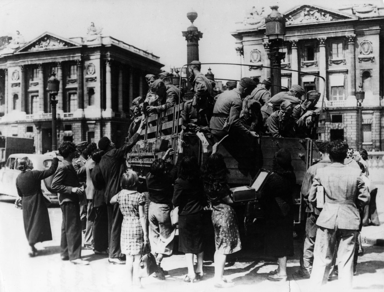 法国街头小贩为卡车上的德国士兵们提供纪念品，1940年7月27日 作者 不明