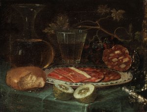 静物画，配有面包片、玻璃水瓶、酒杯、火腿盘和火腿香肠、柠檬和带珍珠母柄的刀 作者 17世纪的伊塔洛佛兰芒画家