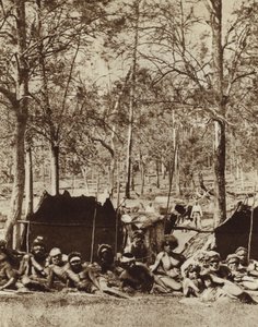 Australian Aborigines sheltering behind a windbreak (b/w photo)