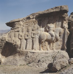 岩画浮雕描绘了Shapur I（公元241-72）和他的家人在他们的帽子上戴着纹章标志，在希腊语，帕提亚语和中波斯语中用三字形铭文 作者 萨萨尼亚人