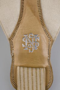 Suspenders, c.1880 (detail view), Emroidered white satin, leather, silver, Maker unknown 作者 未知艺术家