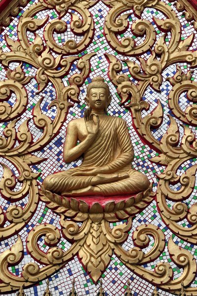 20151102, Vang Vieng, Laos : Entrance door ornamented with gold reliefs. The Teaching Buddha depicts a particular moment in the life of the Buddha, namely, the first sermon the Buddha gave after reaching Enlightenment 作者 不明